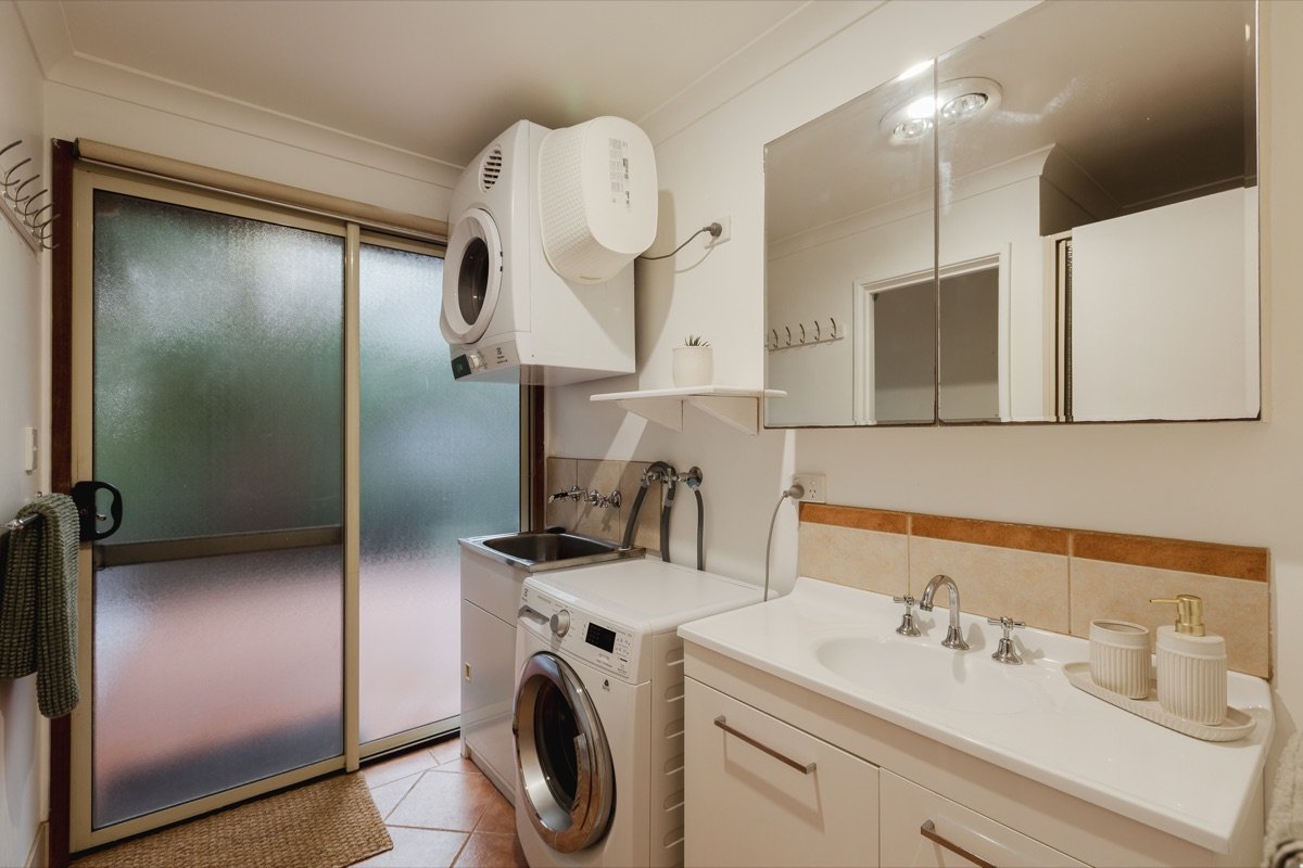 Bathroom and laundry with washer, dryer and vanity